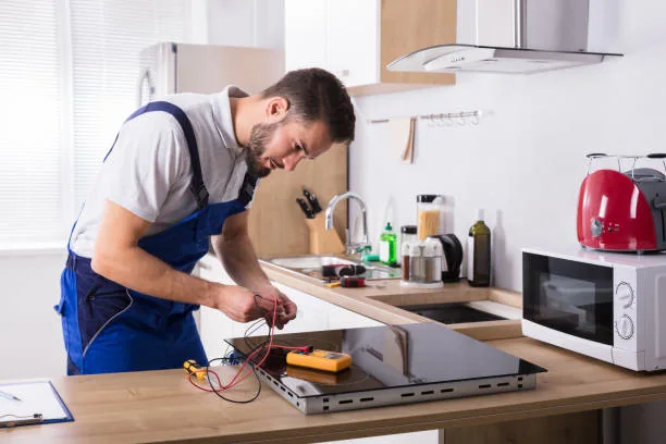 Appliance service professional testing a kitchen cooktop