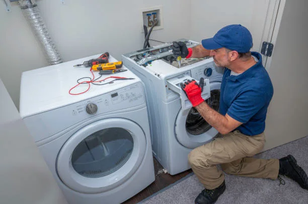 Technician testing controls in a residential laundry room