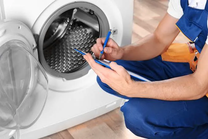 Appliance professional documenting symptoms during an equipment inspection